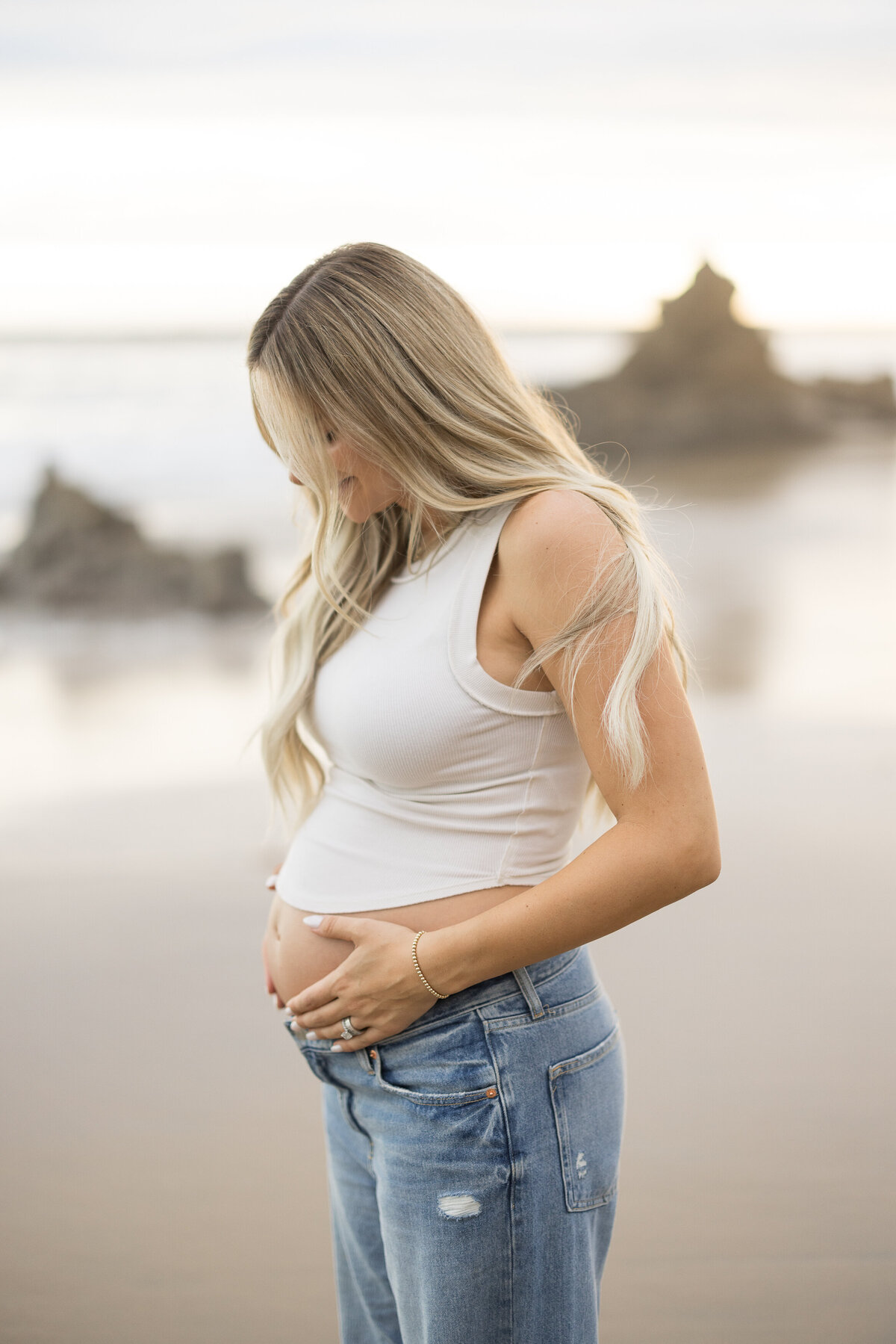 warm and organic maternity photo of mom holding belly