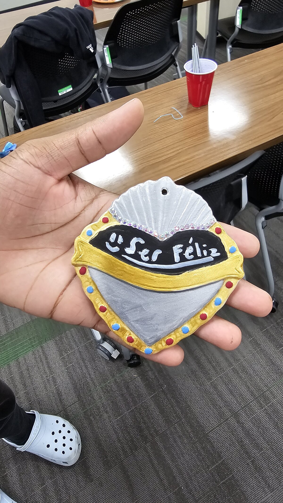 The artistic triumph as a workshop participant proudly presents their final masterpiece—a colorful heart adorned with an inspirational phrase. Tthe materials that brought this creation to life at Soleil Vida Studio.