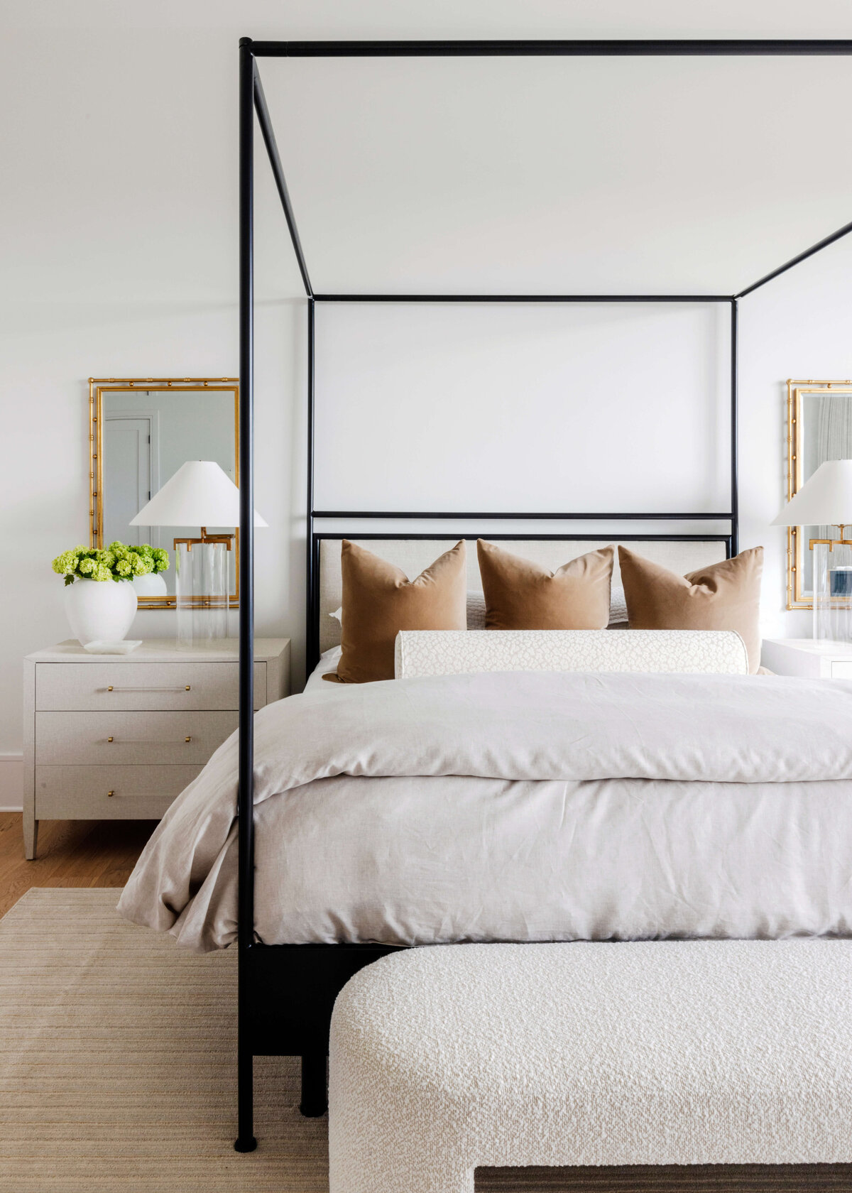 oyster creek studios hughes black canopy bed with white bedding and bedside table in bedroom
