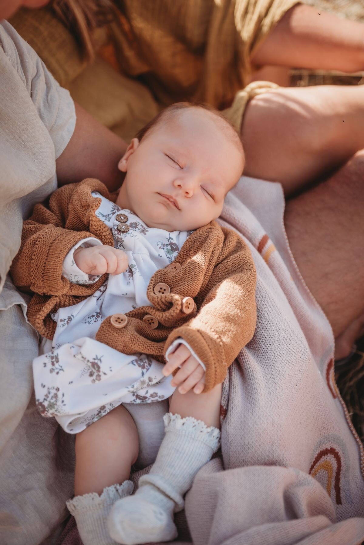 a newborn baby in dads arms captured by Bie during a newborn session in wanaka