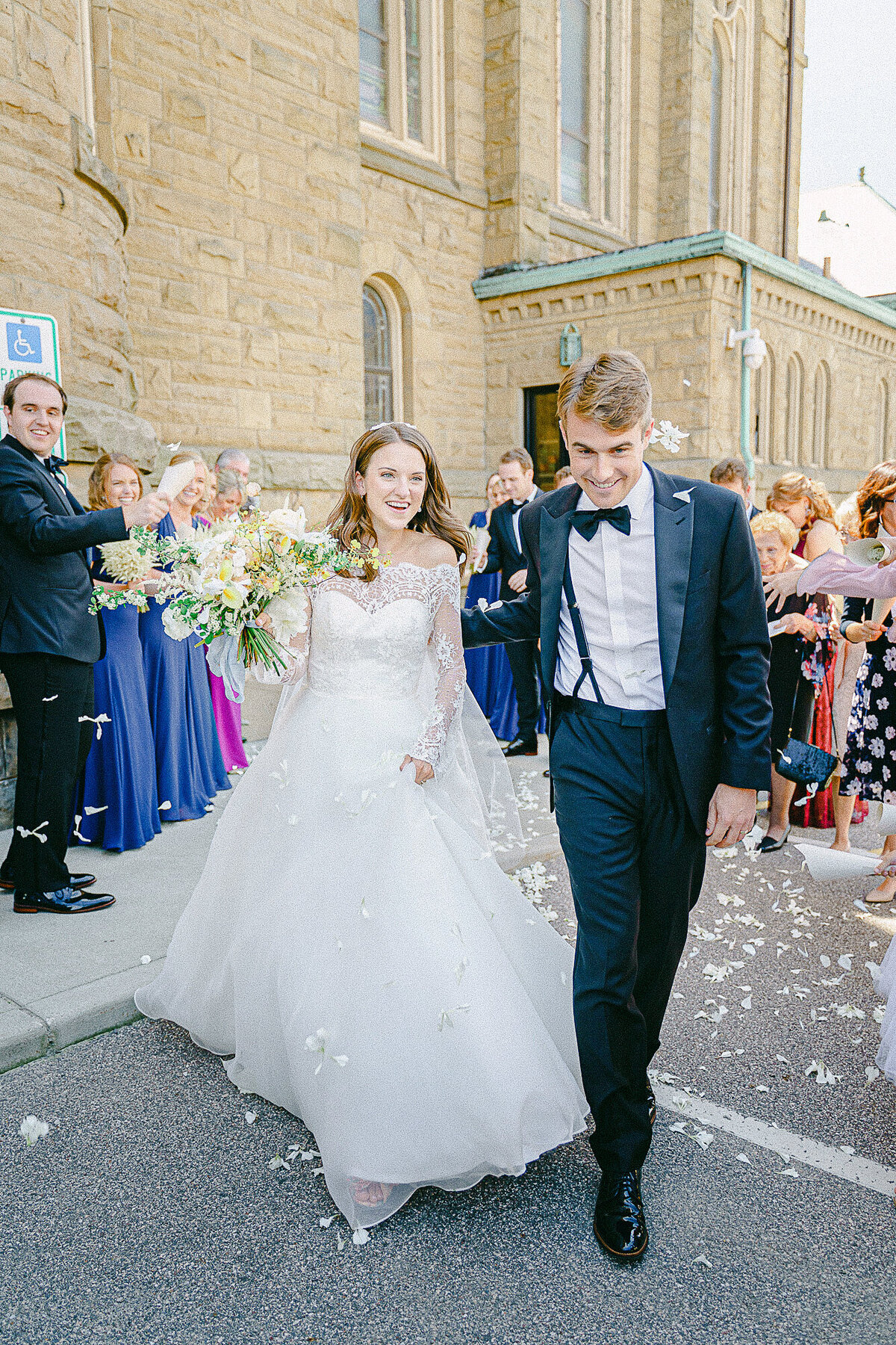 Bride and Groom make a rose petal getaway at their intimate wedding ceremony