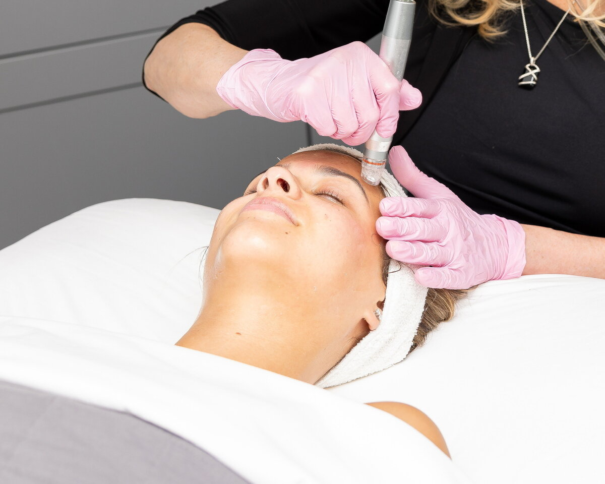 a woman receiving a skin treatment on her face