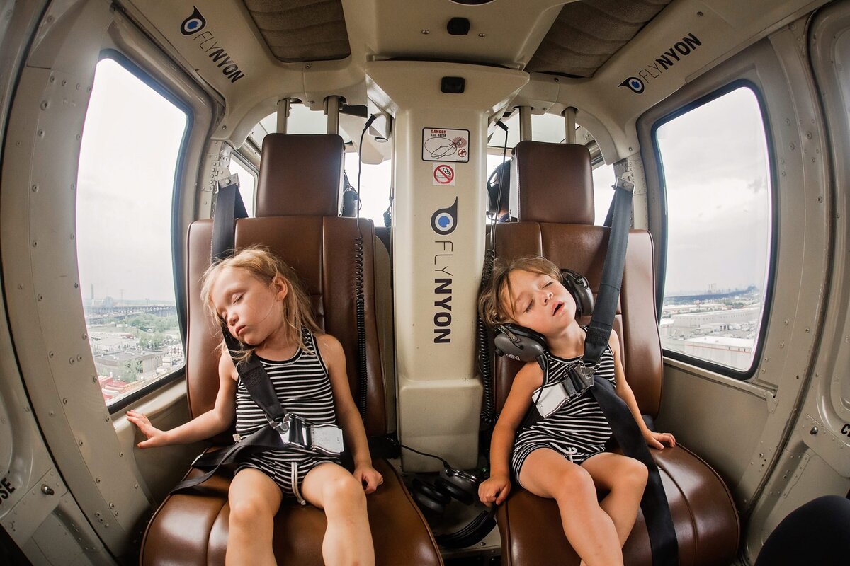Two toddlers fall asleep while on a helicoptor ride in New York City.