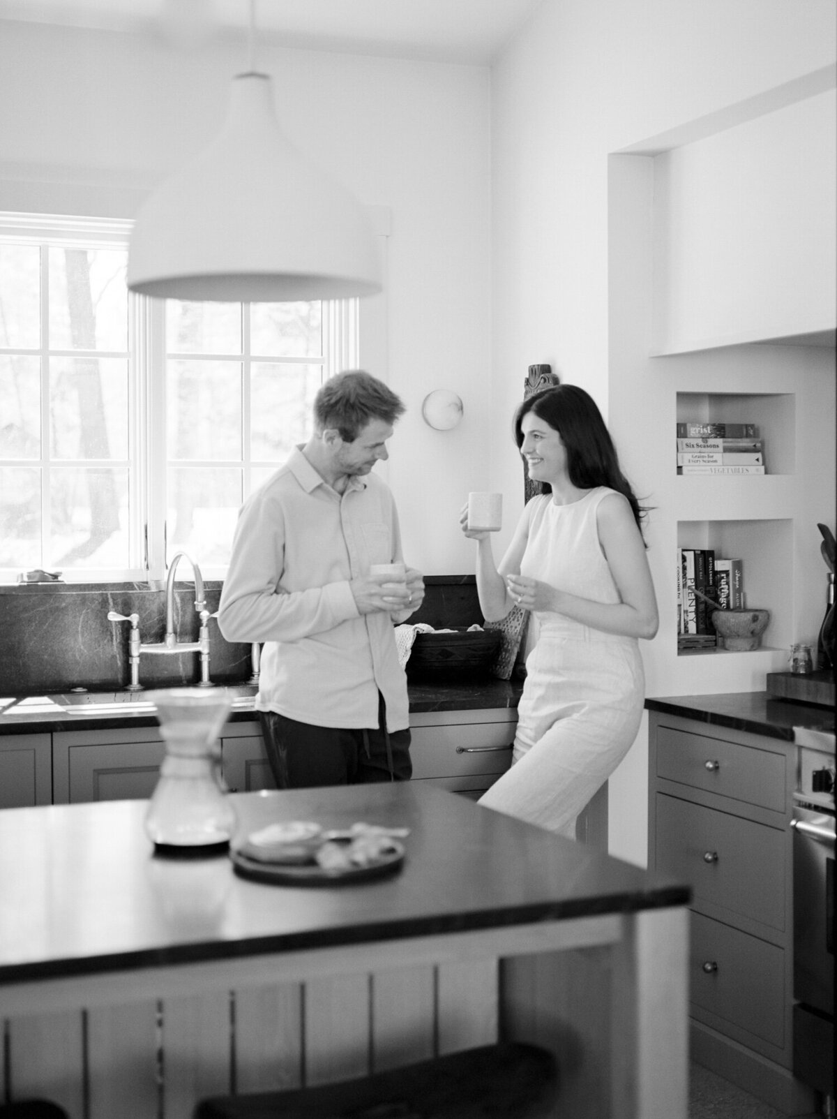 a couple shares afternoon coffee in the kitchen at Fernhaus, lifestyle interior photography, film branding photos