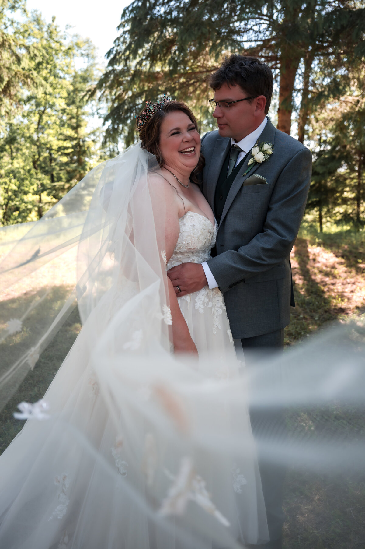bride laughs and smiles in romatic wedding portrait