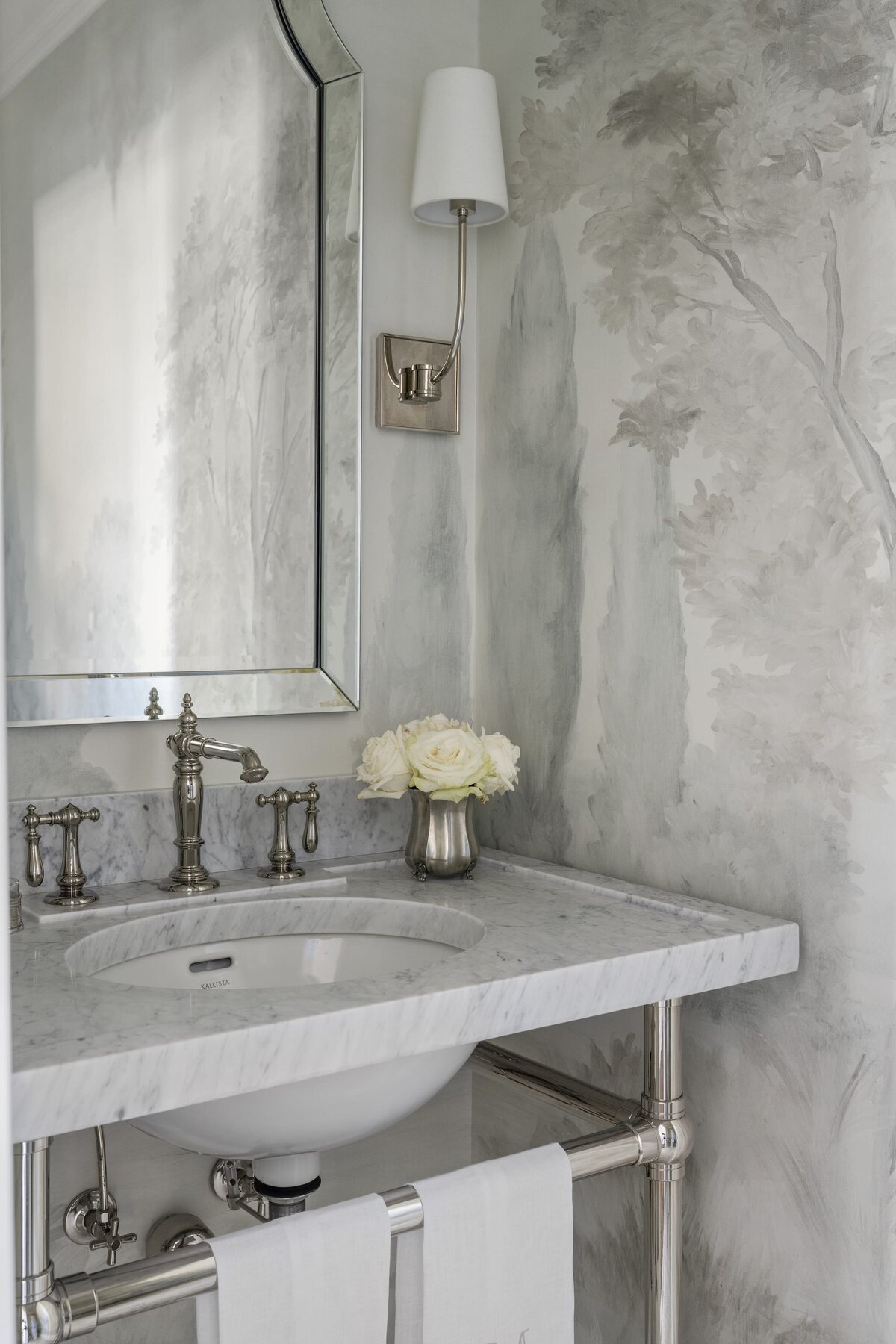 candra lynn interiors ocean port project bathroom sink with white roses on counter and silver finishes