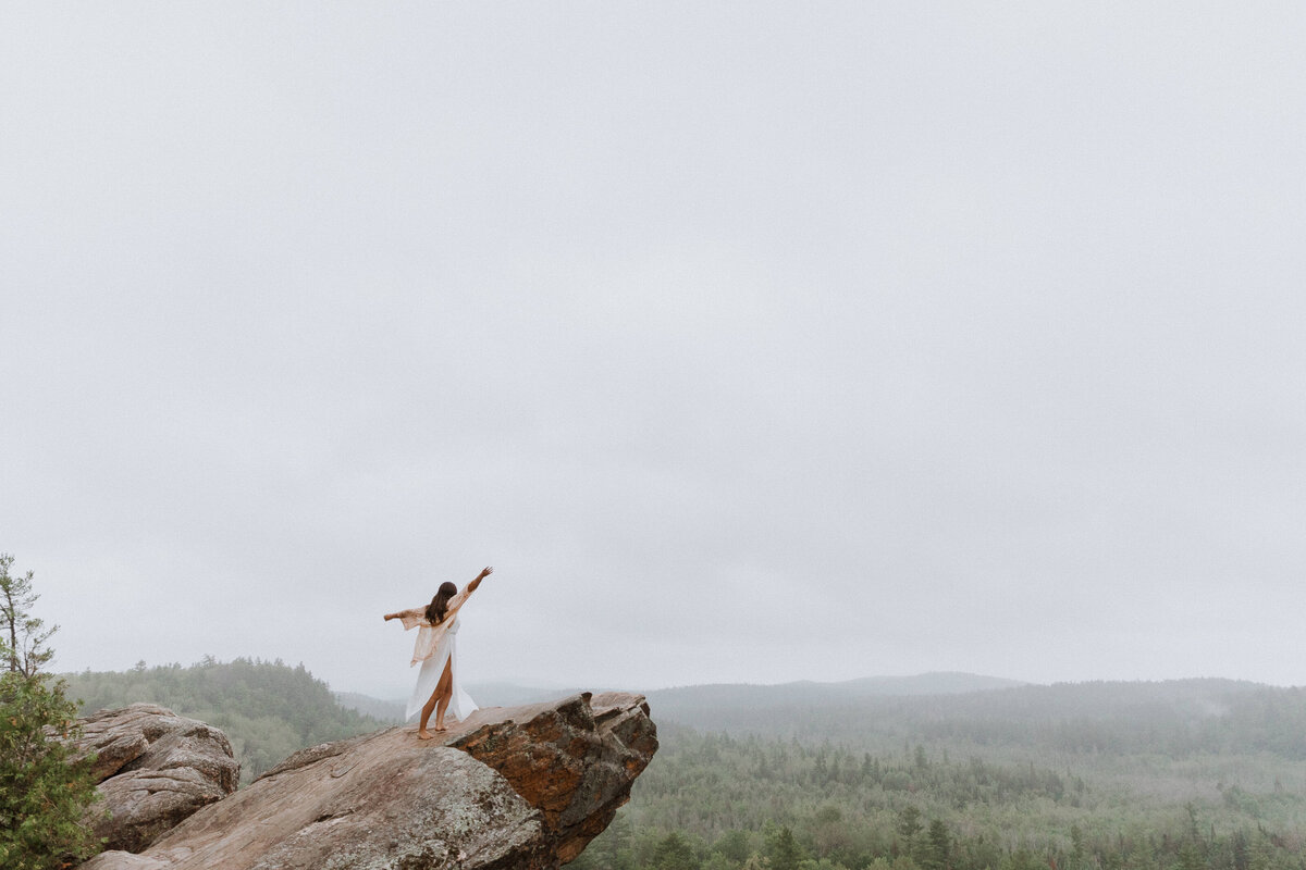 woman on hill in mountain yoga pose