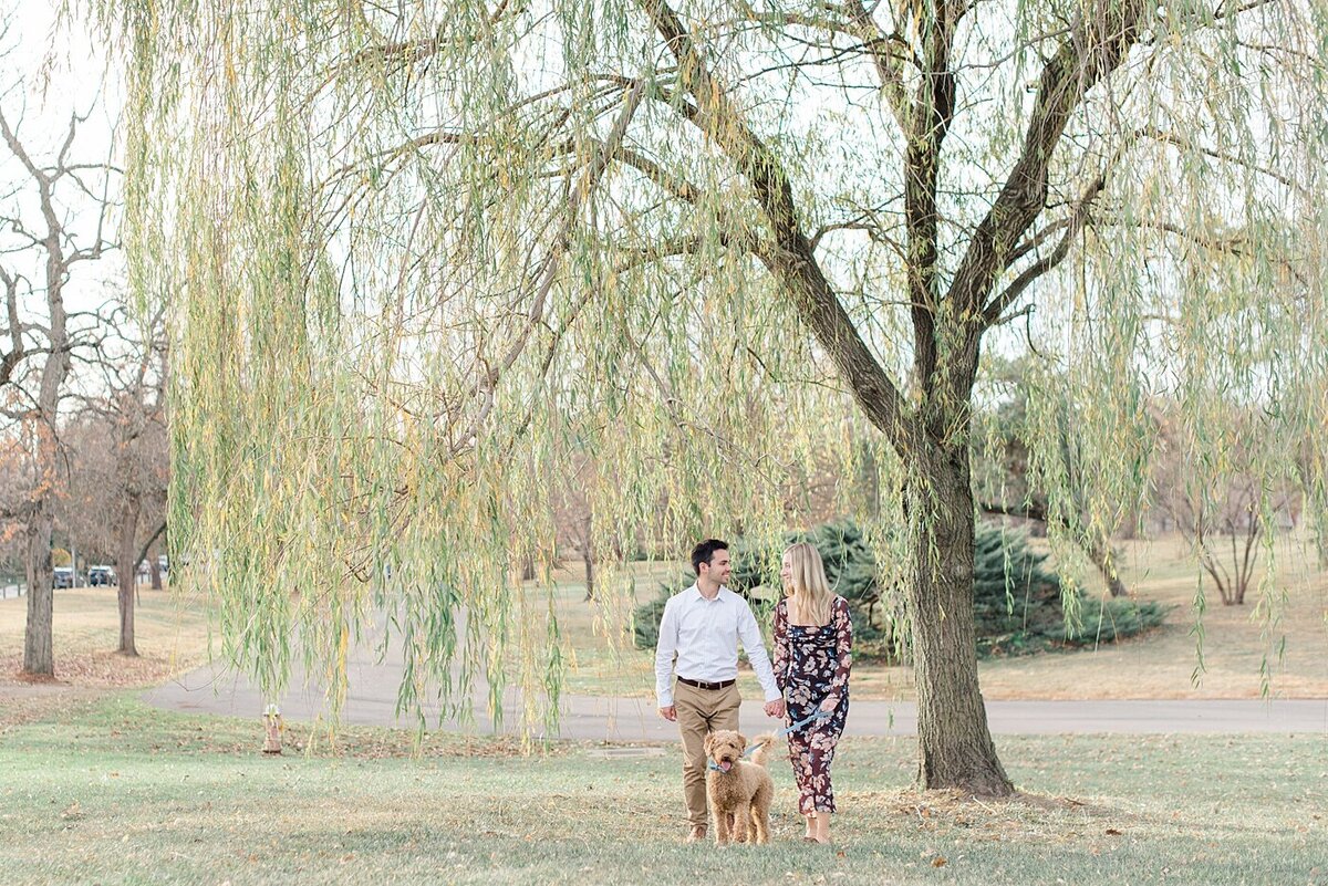 Couple walking dog at Franklin Park engagement session photographed by Ohio Wedding Photographer