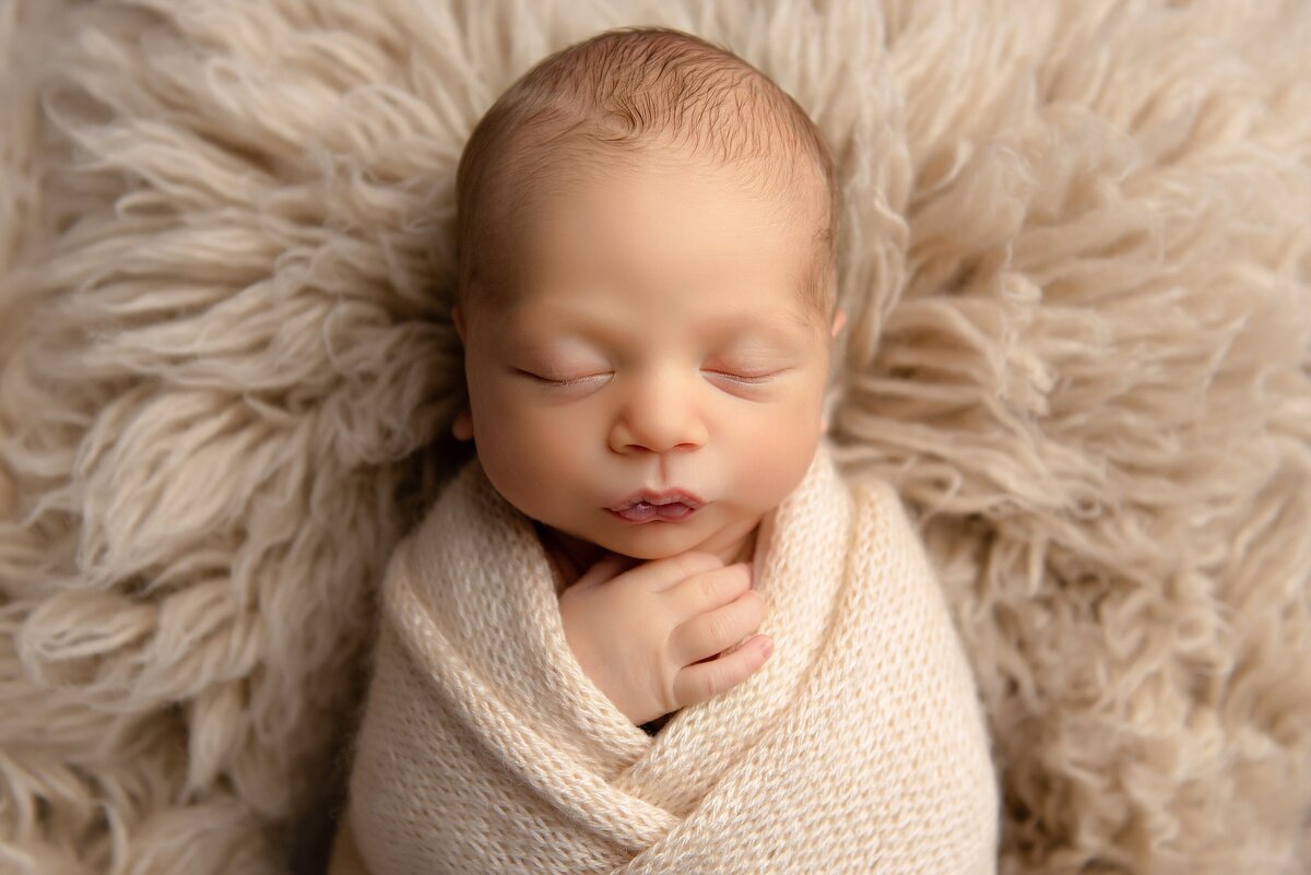 Baby in classic neutral simple theme by best West Palm Beach newborn photographer.