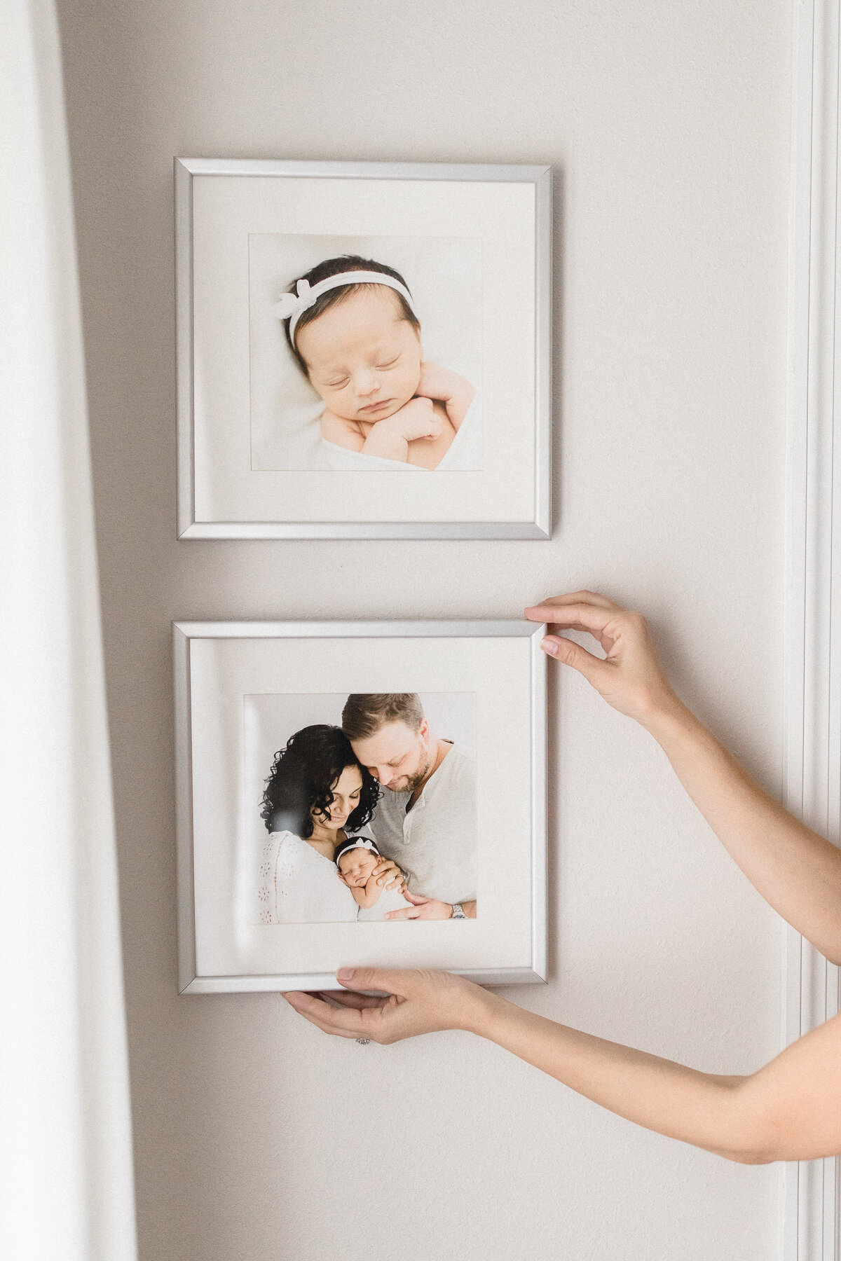 Fresno Photographer showing framed artwok newborn session family portraits