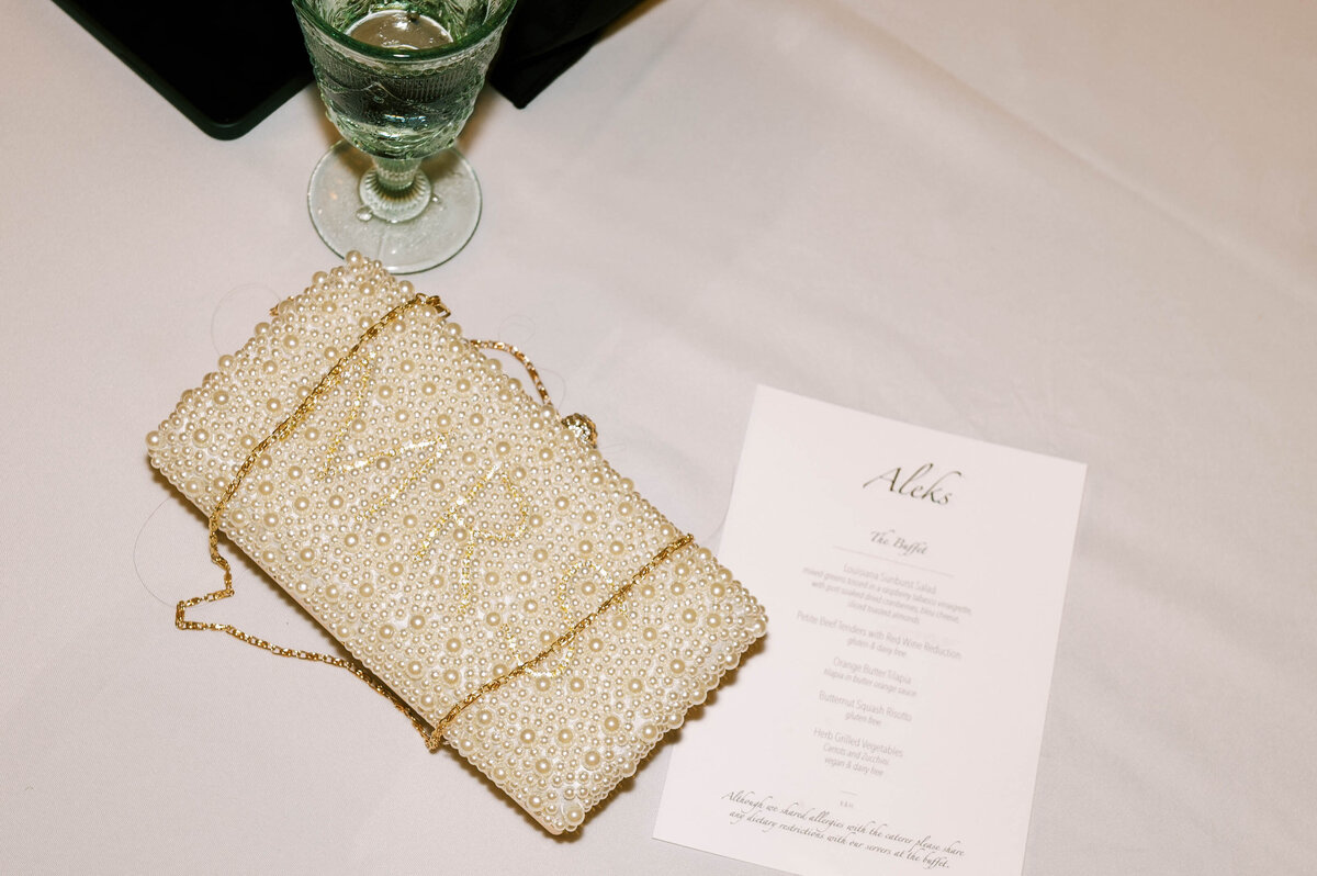 a pearl purse and a dinner menu at a littleton wedding by Colorado wedding photographer JKG Photography