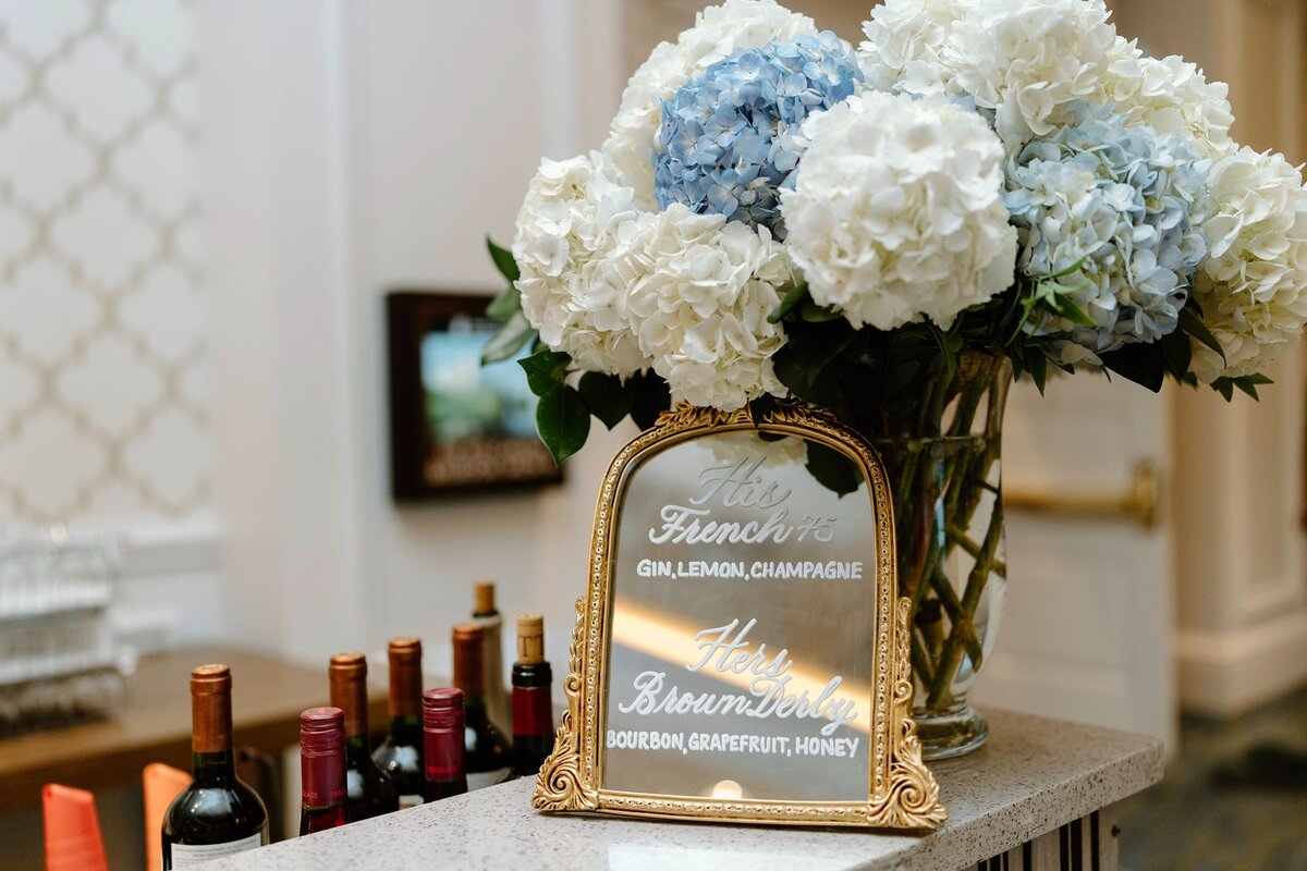 5x7 and 8x10 gold mirrors with ornate decor on the top and calligraphy for bar sign