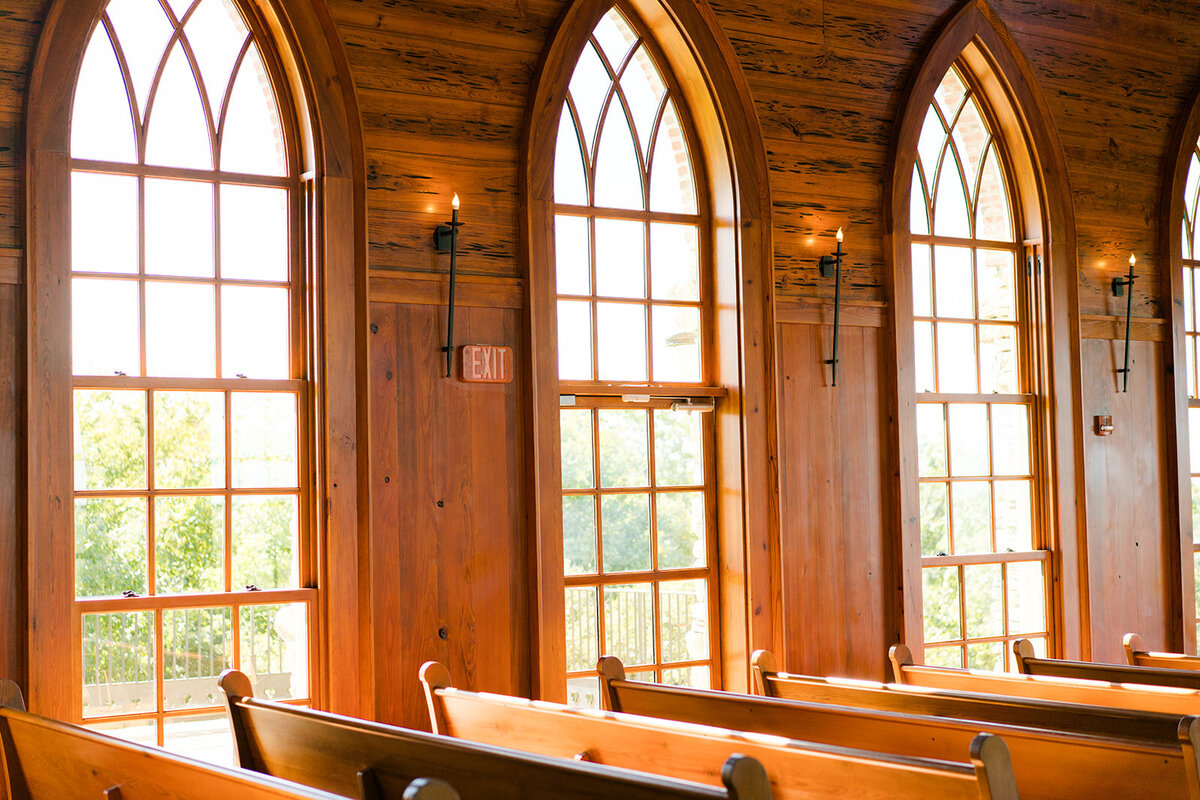 glass windows and wooden pews at a church
