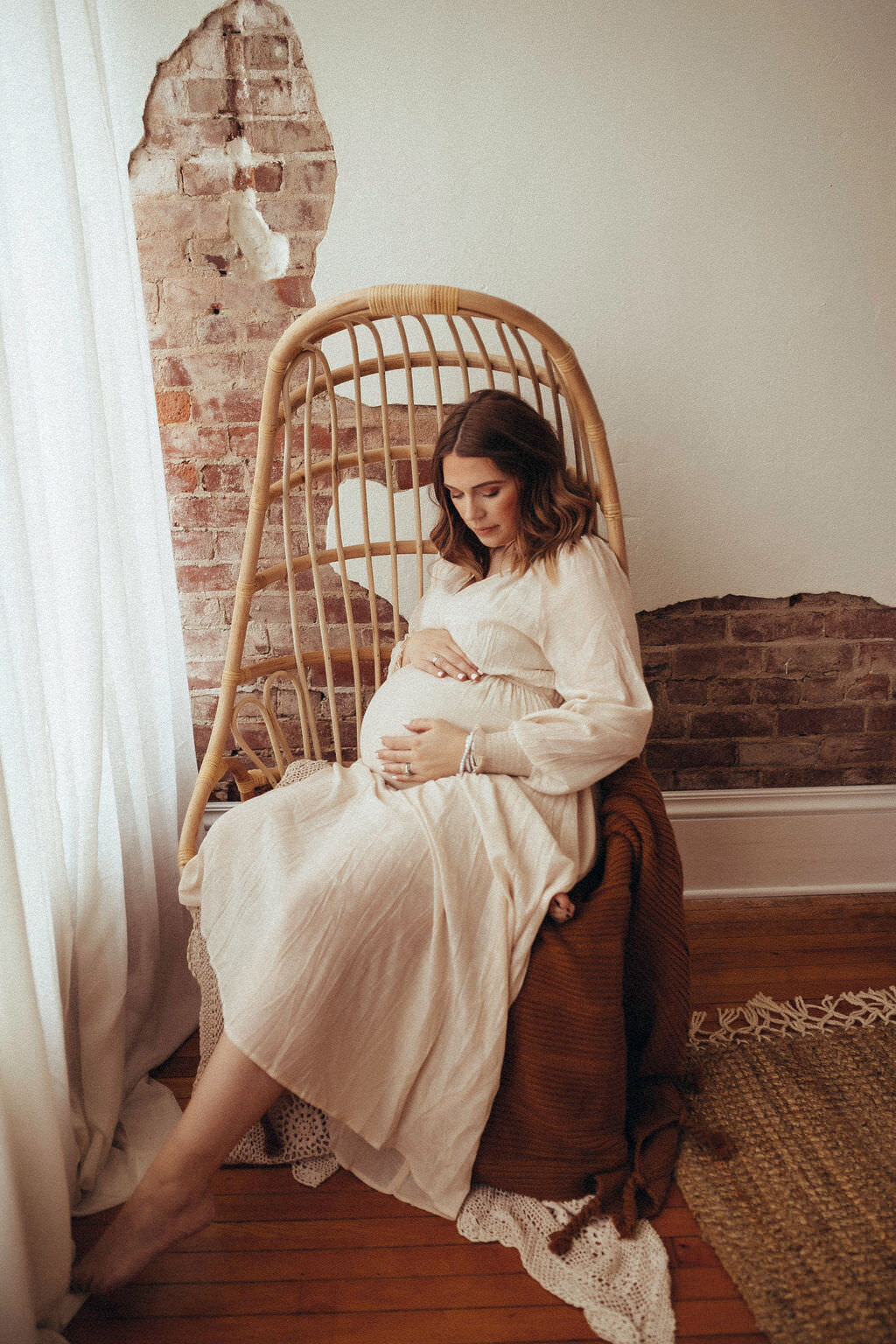 pregnant woman sitting in chair posing