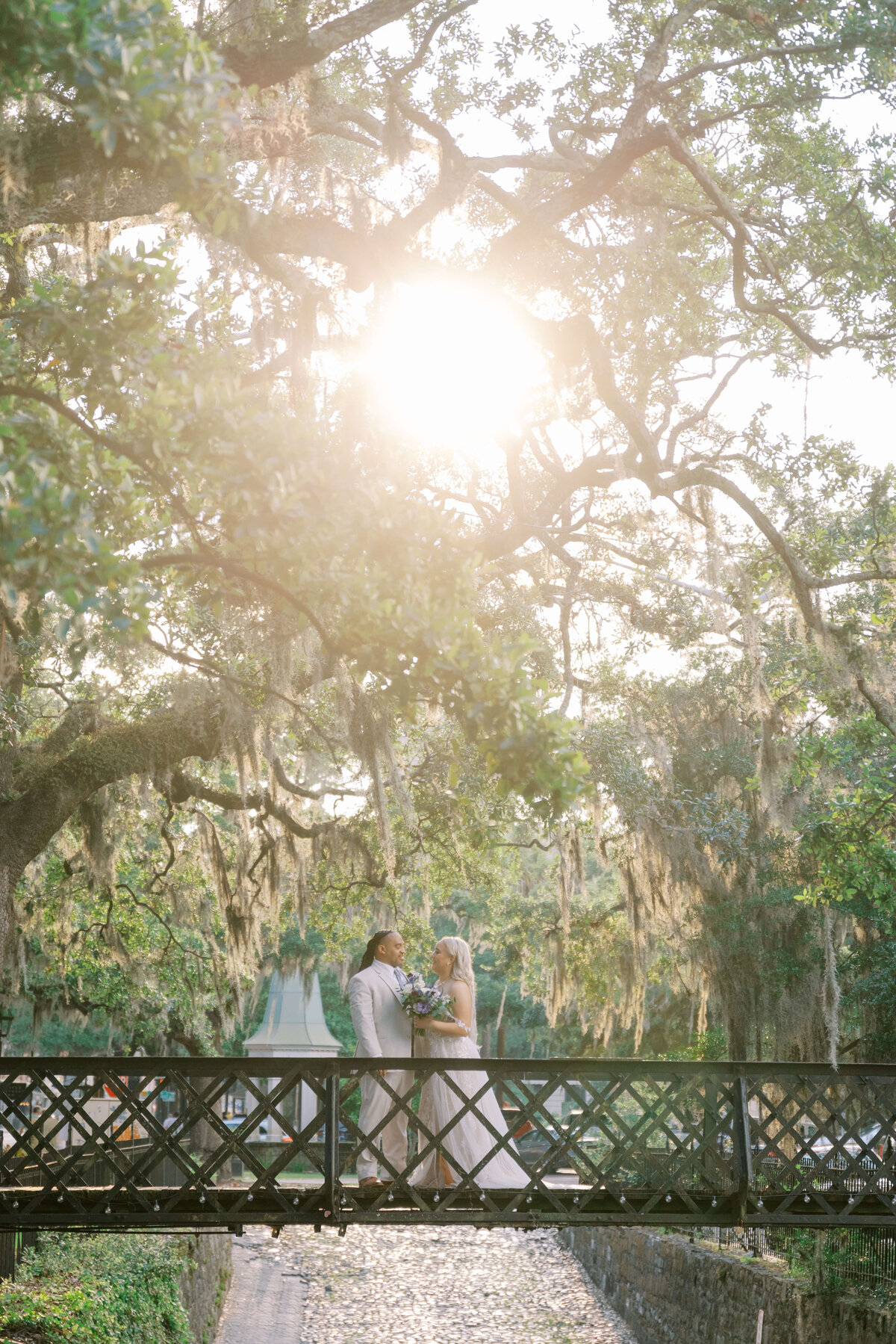 A touching exchange of vows during a Forsyth Park elopement ceremony, beautifully framed by the historic oak trees.