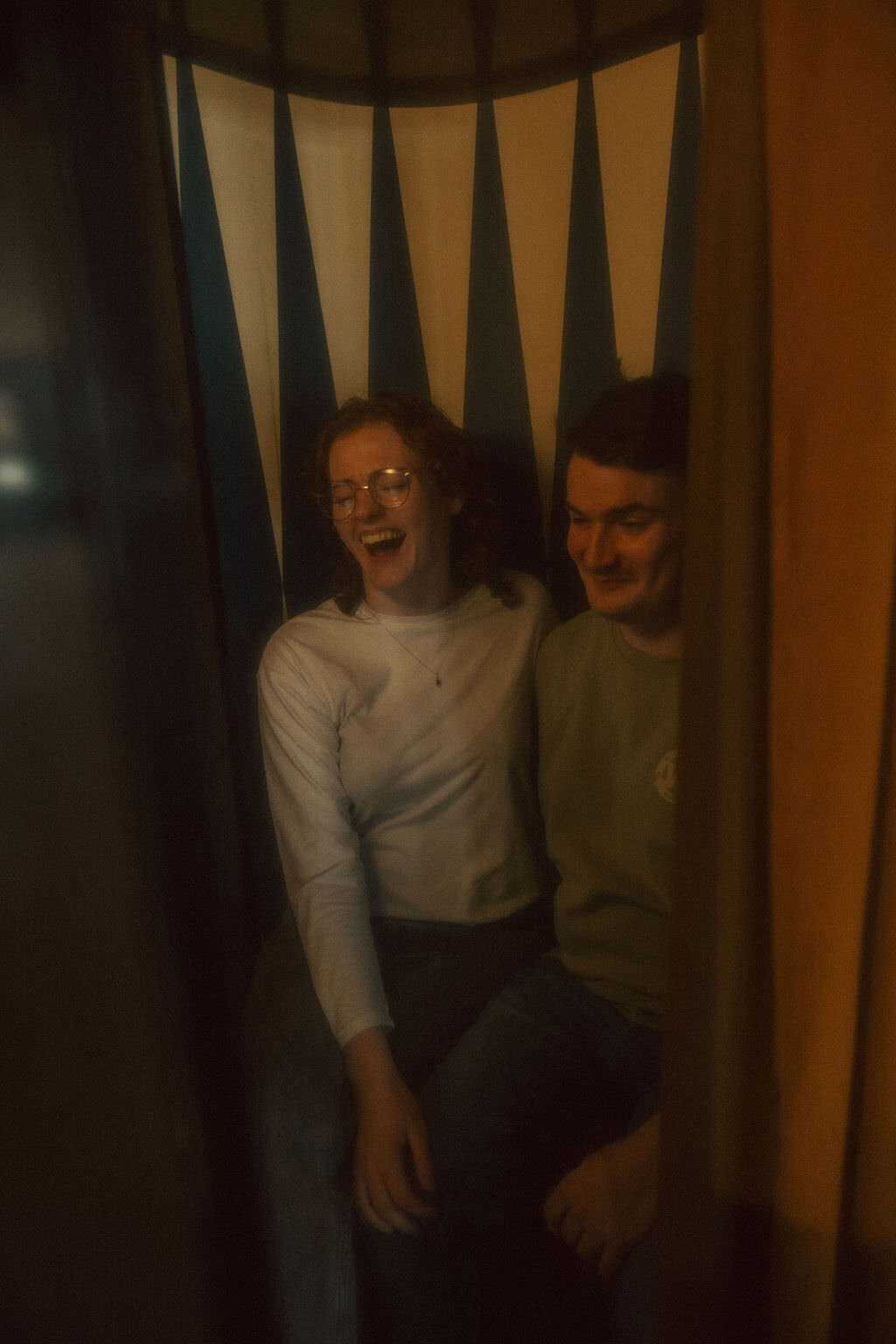 A couple laughing in a photobooth