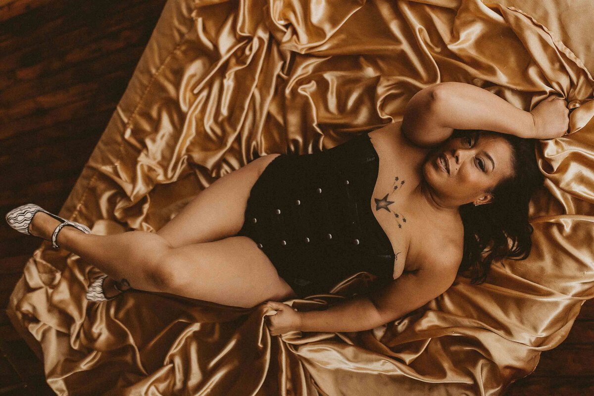 woman laying in the floor while doing a pose
