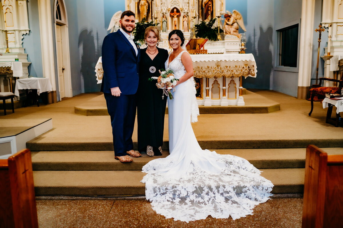family photo pose in catholic church after wedding in Delcambre, la