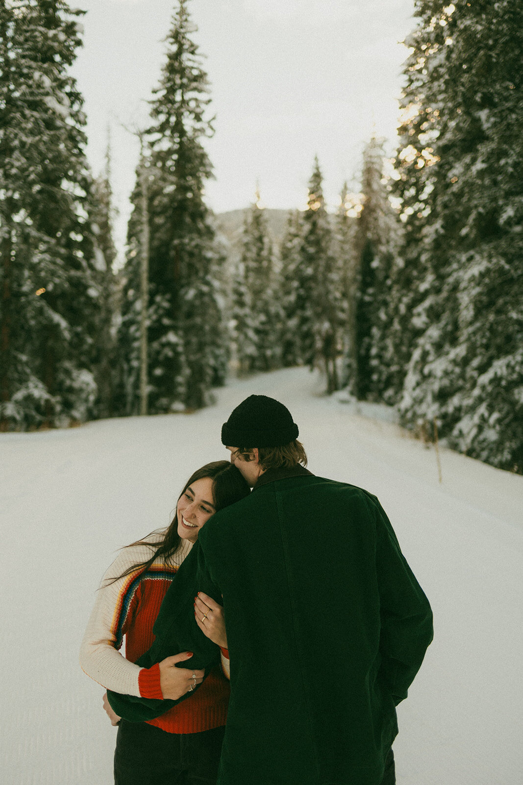 couple in snow holding eachother