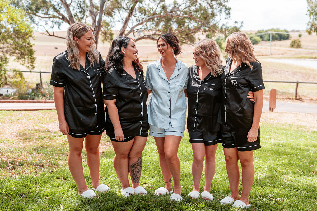 Bridesmaids having fun with Mikaeley, smiling together