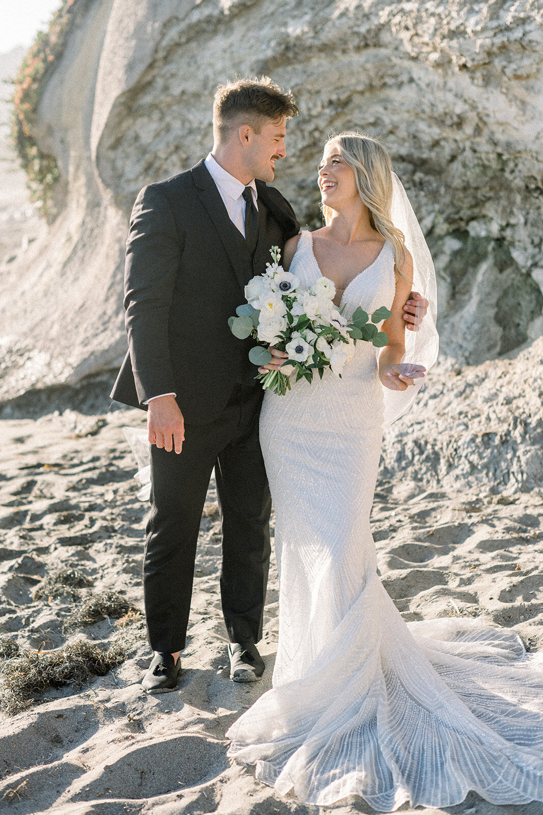 Bride and groom the beach at sunset at Dolphin Bay Resort in Pismo Beach, CA