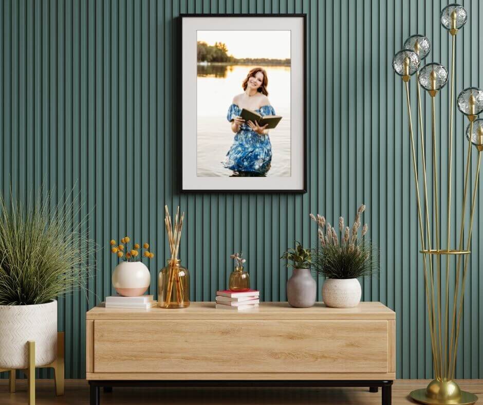 gorgeous print of a high school senior framed and hanging above a buffet in the front entryway of a home in Neenah.