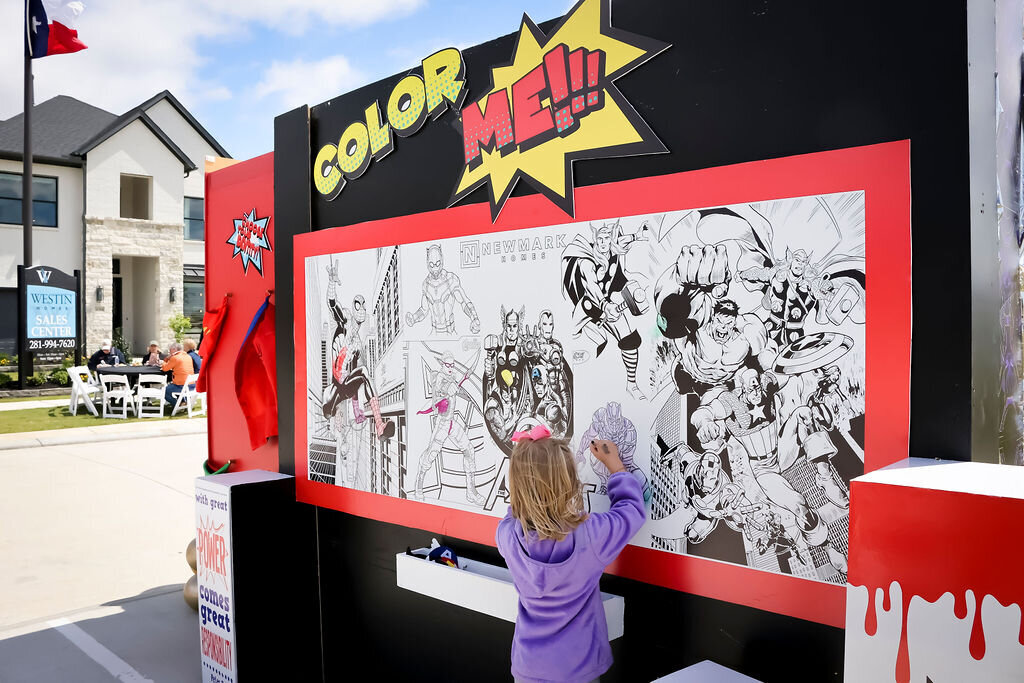 Newmark Homes corporate event Superhero themed backdrop design with large interactive coloring display