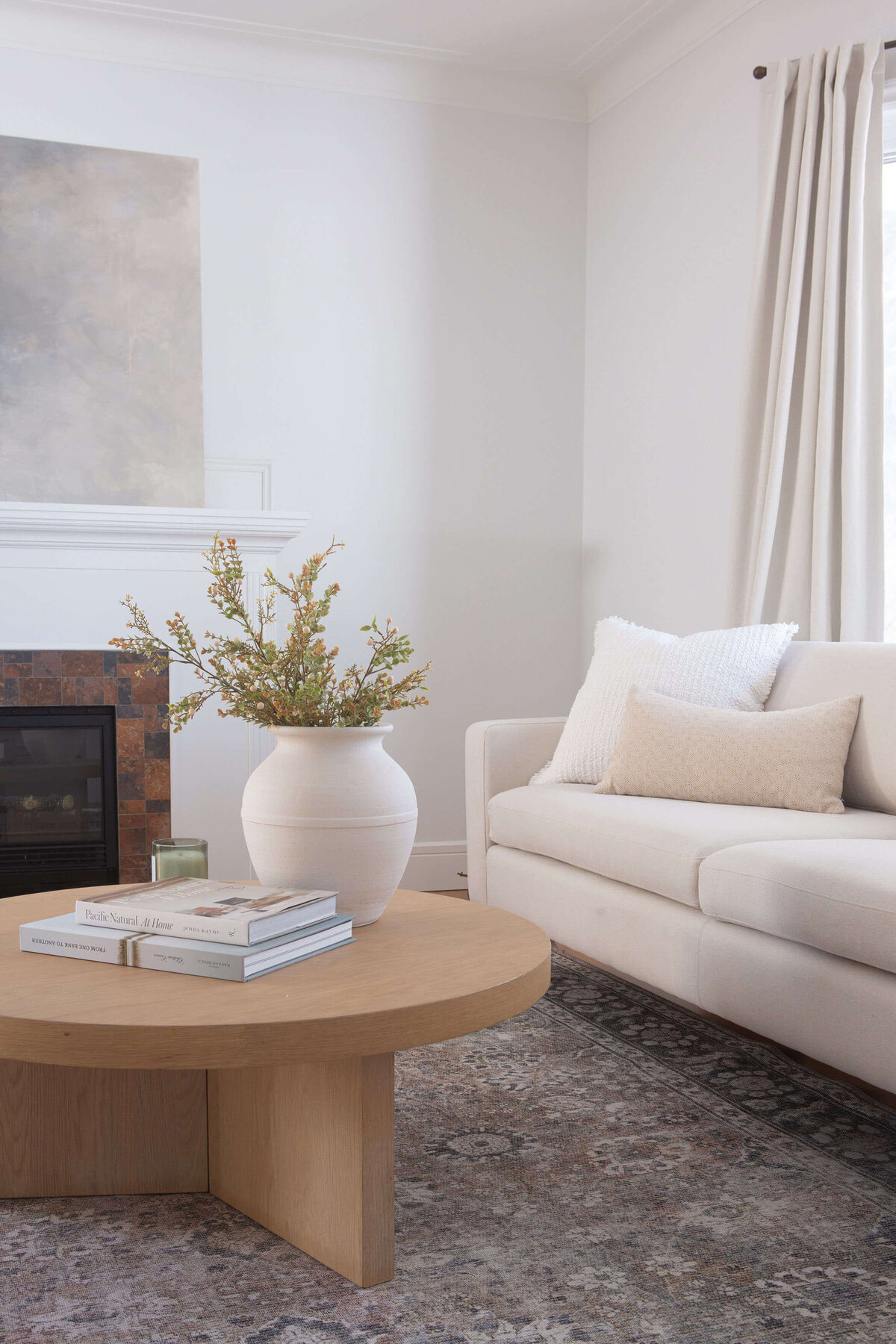 character home living room staged with patterned traditional rug and modern round oak coffee table