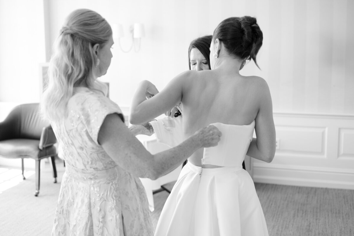 bride getting dressed at Mission Hills Country Club Kansas City wedding