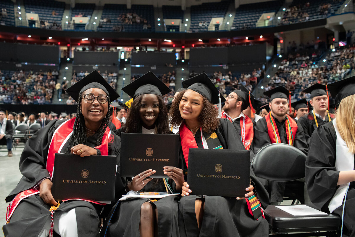 three graduating females in XL center