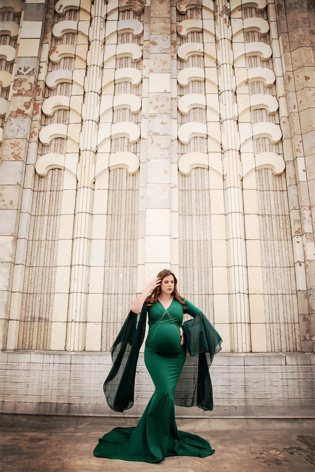 st-louis-maternity-photographer-mom-in-green-gown-in-front-of-large-wall