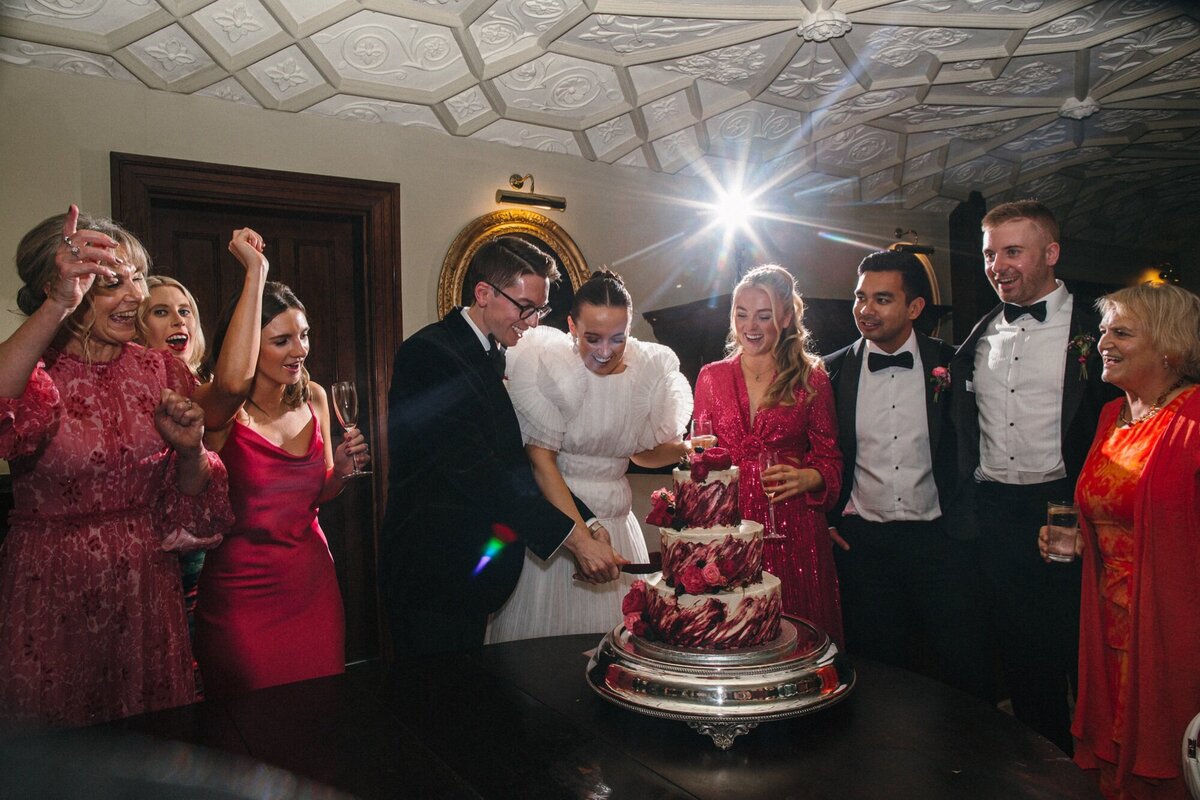 Cake cutting photo at a wedding in Devon