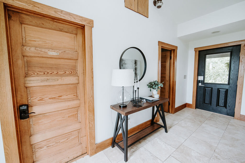 the entry hallway with black door of the modern farmhouse overnight accommodations at Willowbrook wedding venue near Volant, PA