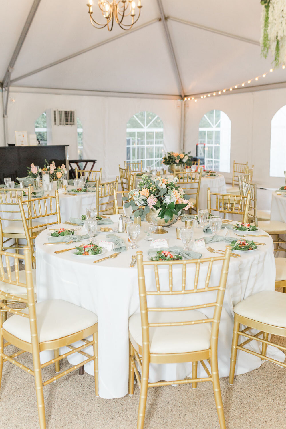 Luxury wedding tables design with floral centerpiece and golden chairs