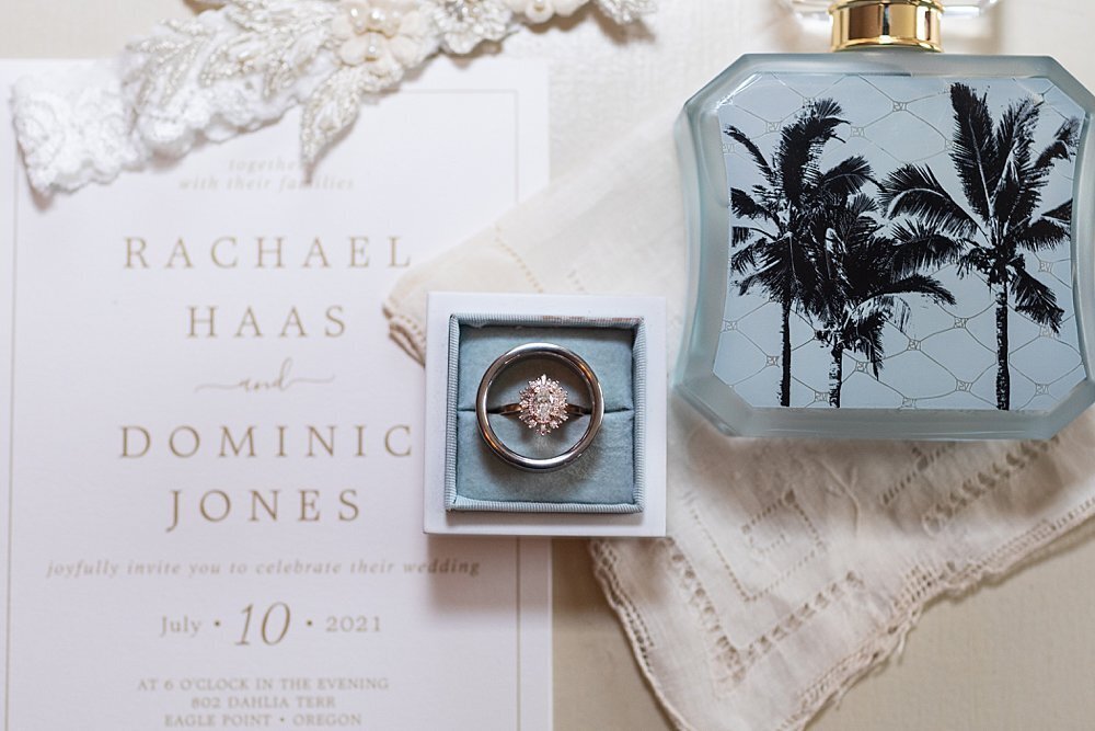 Vintage blue bridal details with wedding rings and perfume bottle