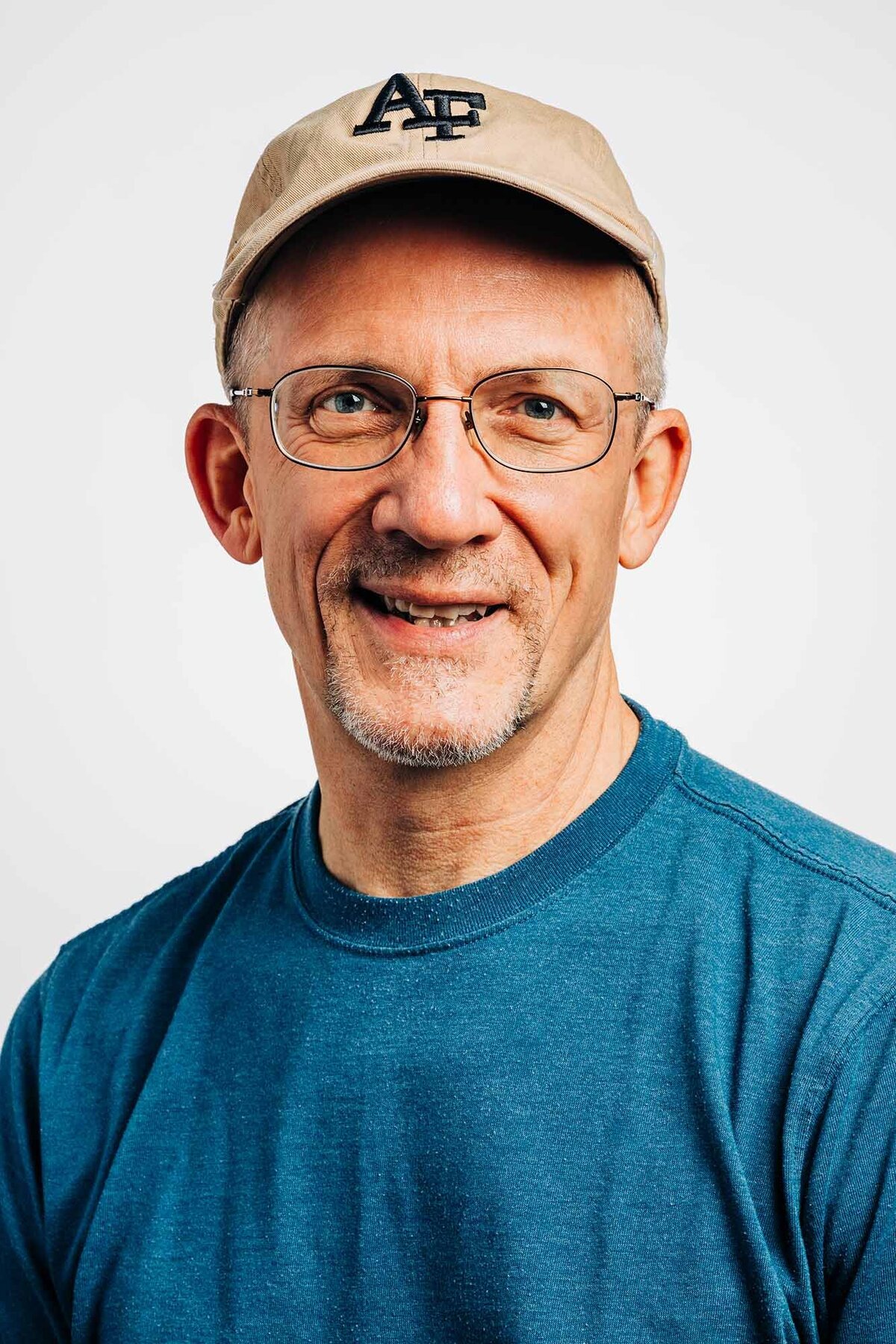 Studio headshot of Montana man with baseball cap