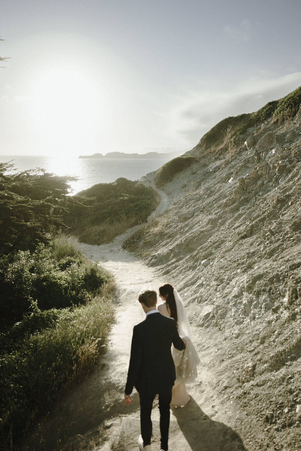 Bride and Groom at Marshall's Beach in San Francisco, California at sunset