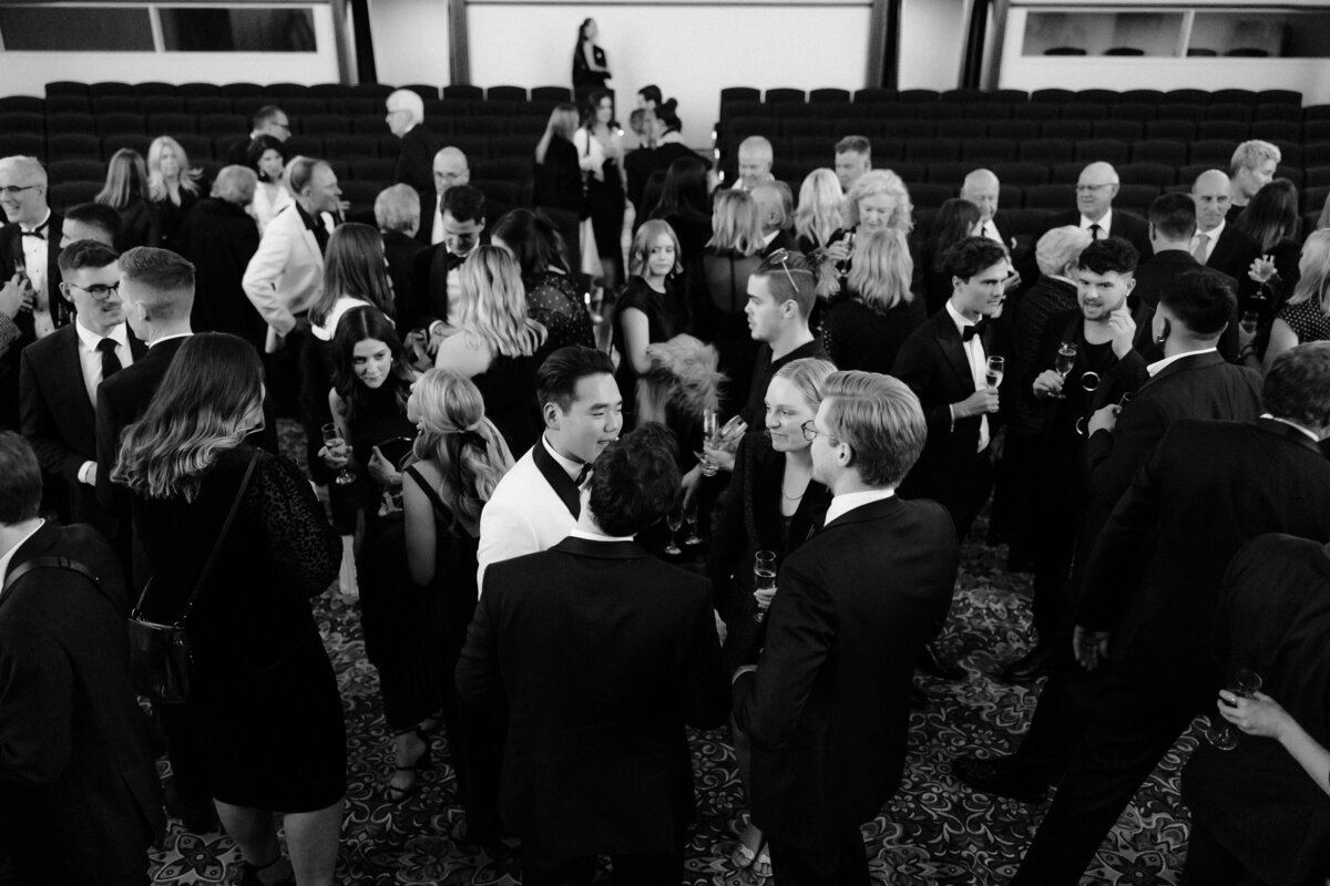 A high angle shot of the guests at regal cinema wedding in black and white.