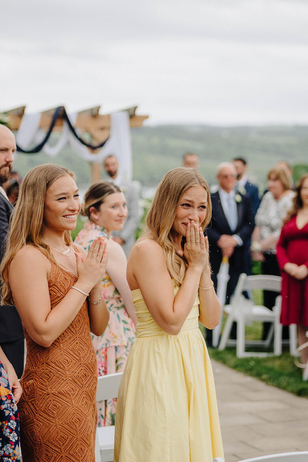 Bridesmaids looking emotional at outdoor finger lakes wedding