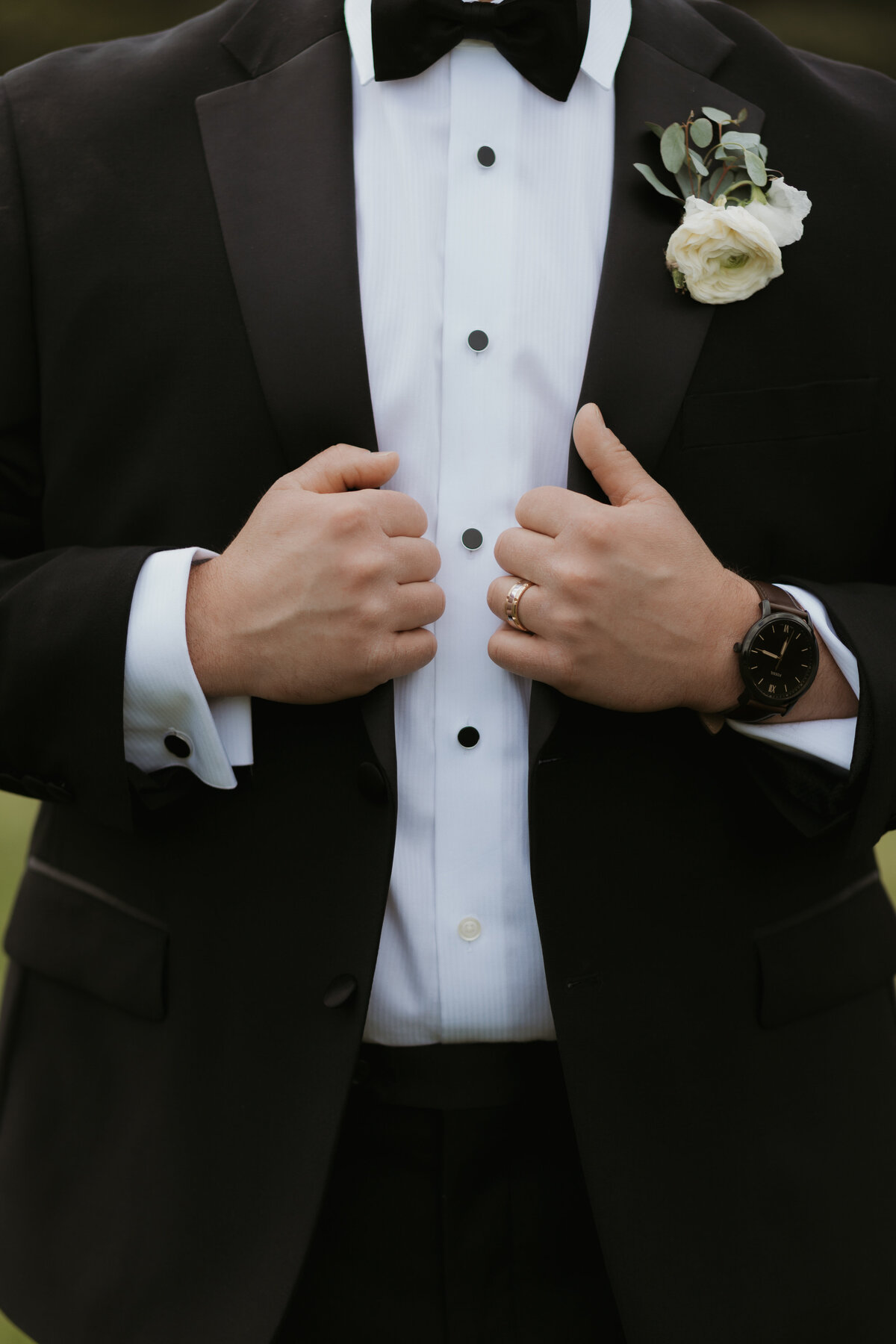 detail shot of groom and his suit and ring