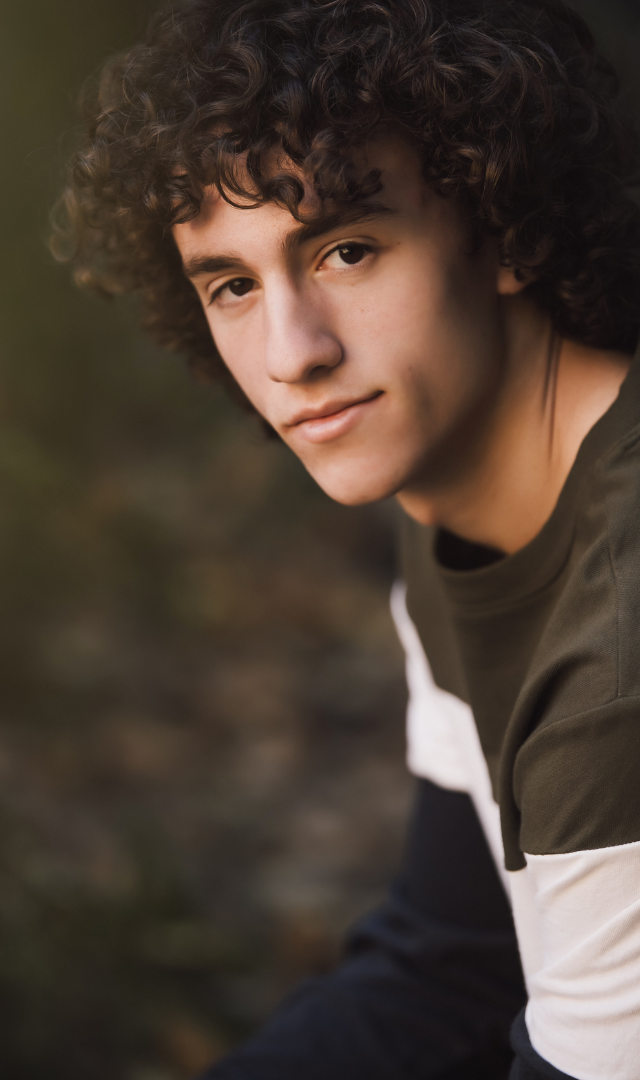 portrait of curly haired high school senior boy