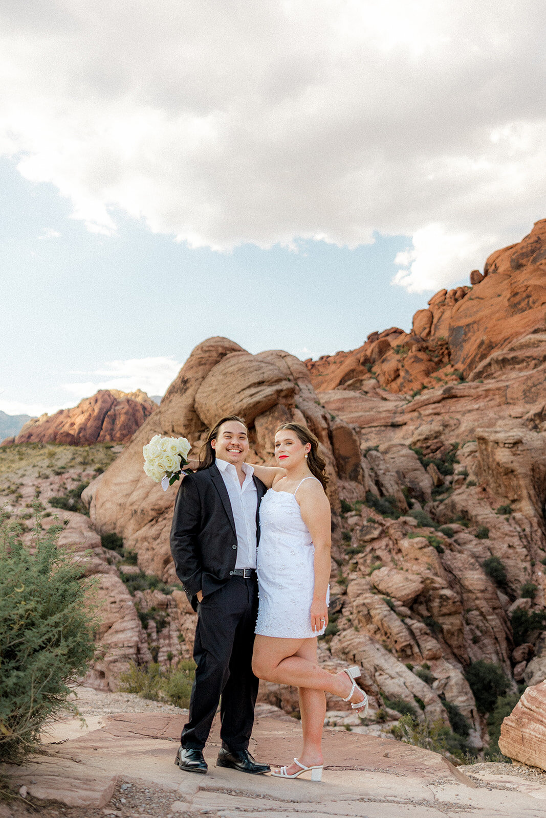 Engaged couple with girl bending her leg up at the Red Rock Canyon
