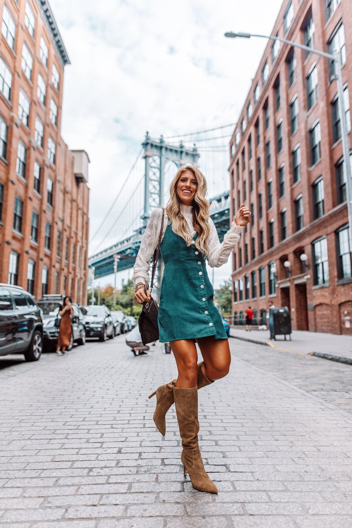 Blonde girl with boots on brick road
