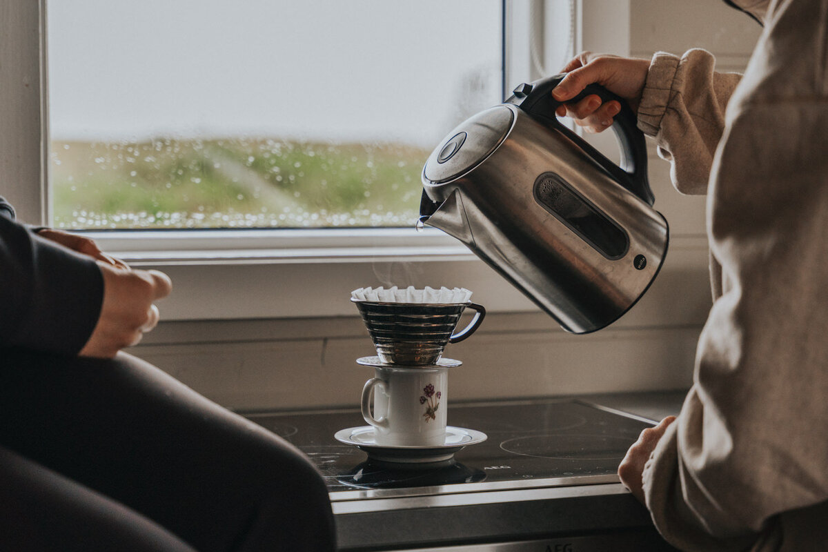 Brides make a pour over in their cozy Iceland cottage  