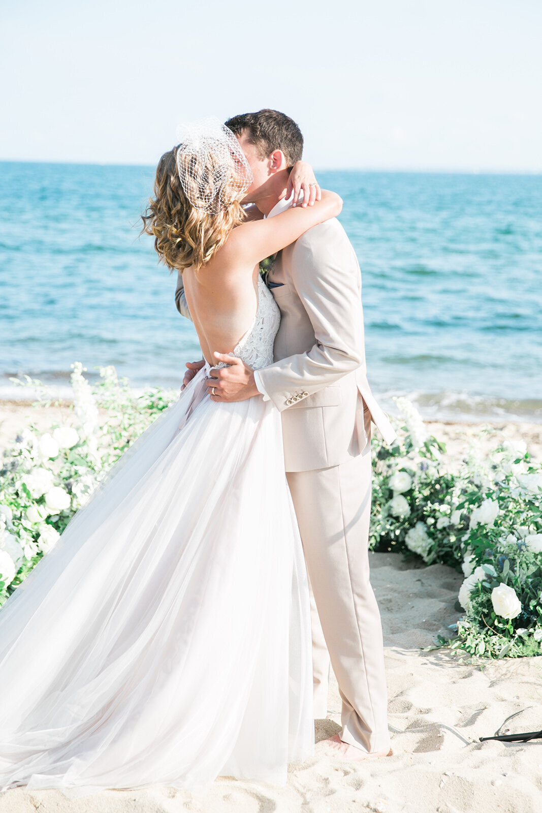 Couple kisses along Connecticut shores in wedding ceremony