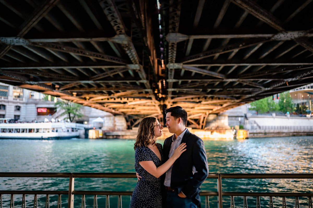 A couple embrase  under a bride on the Chicago Riverwalk