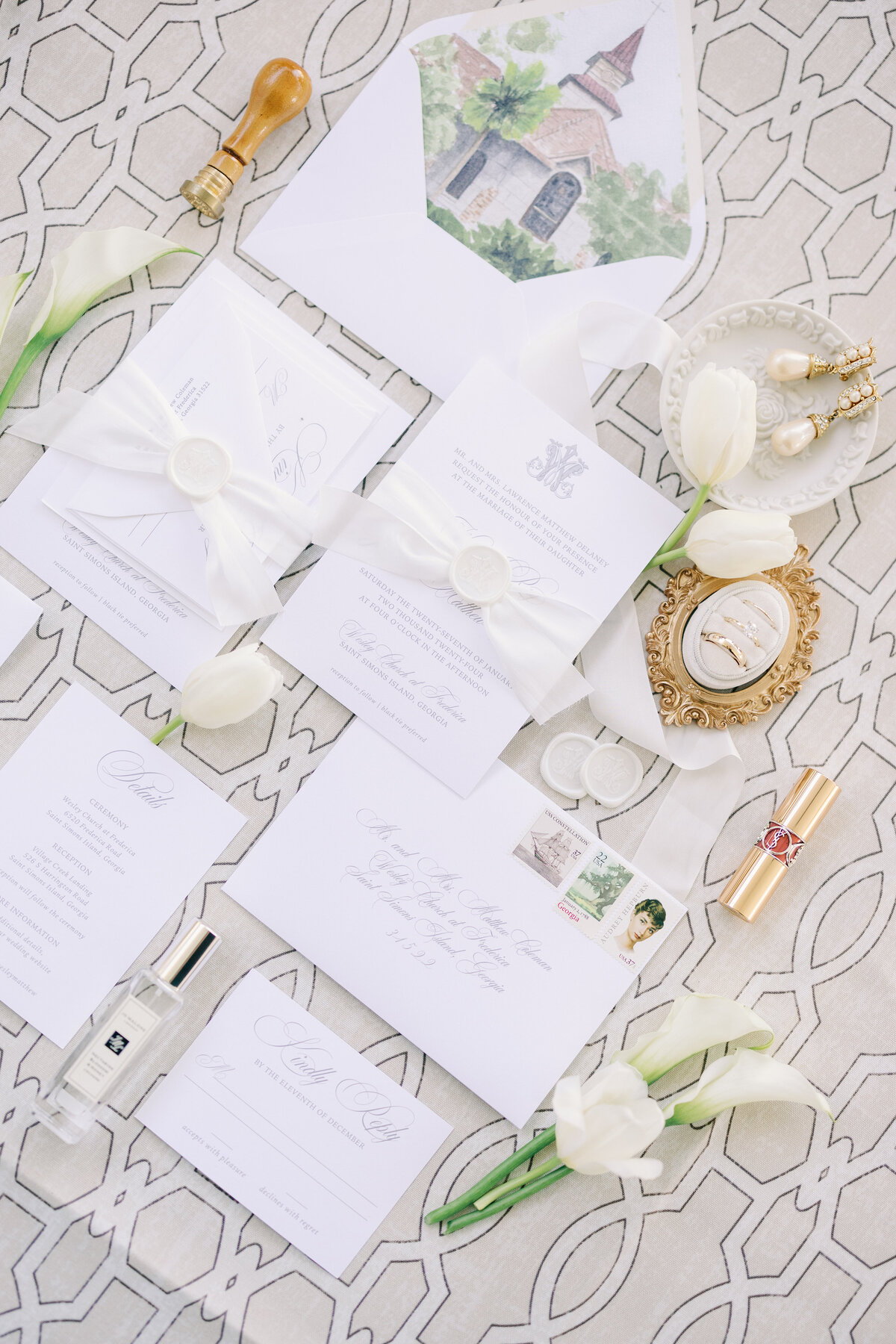 a wedding flat lay featuring stationery with a light neutral color palette