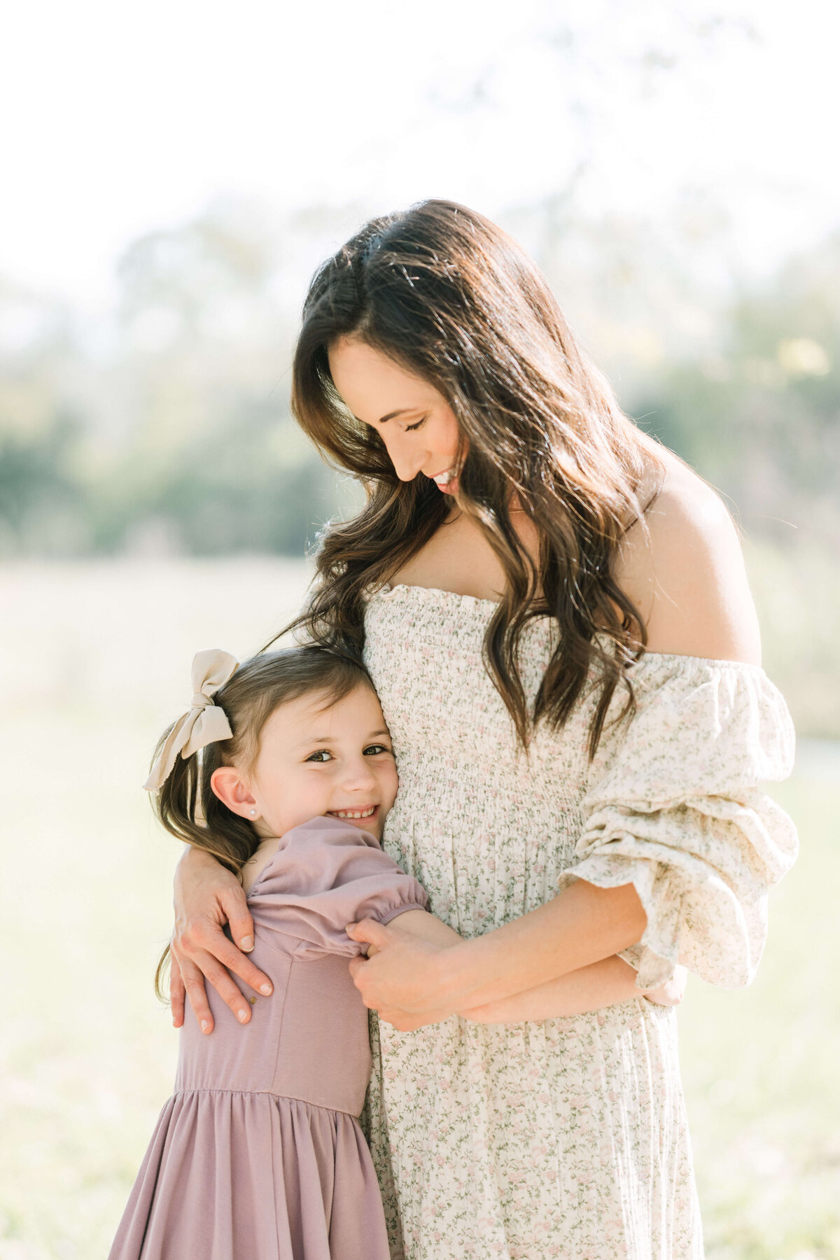 Mother and daughter hug during a Baton Rouge Mommy & Me family session