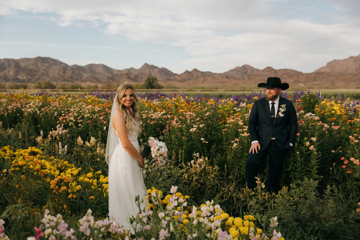 Bride and groom in wildflower field at golden hour, West Coast wedding photography in Yuma, Arizona
