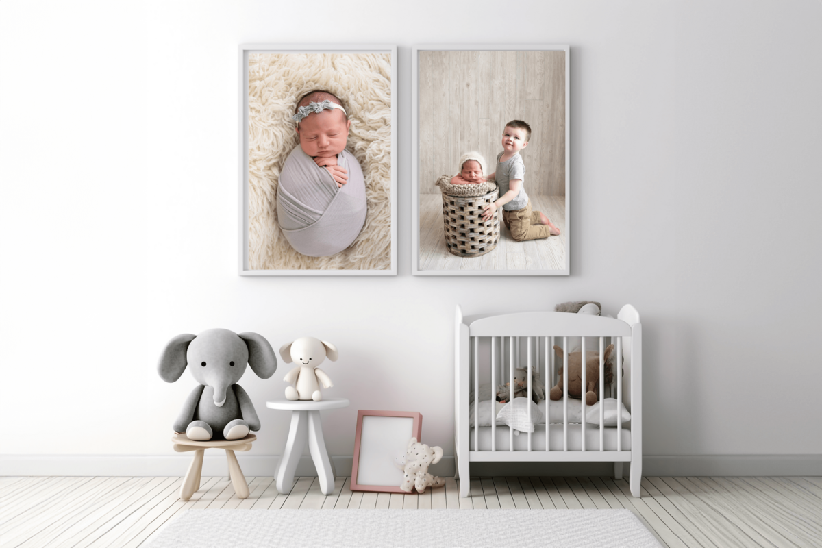a white room with two framed newborn photos for their newborn photography session